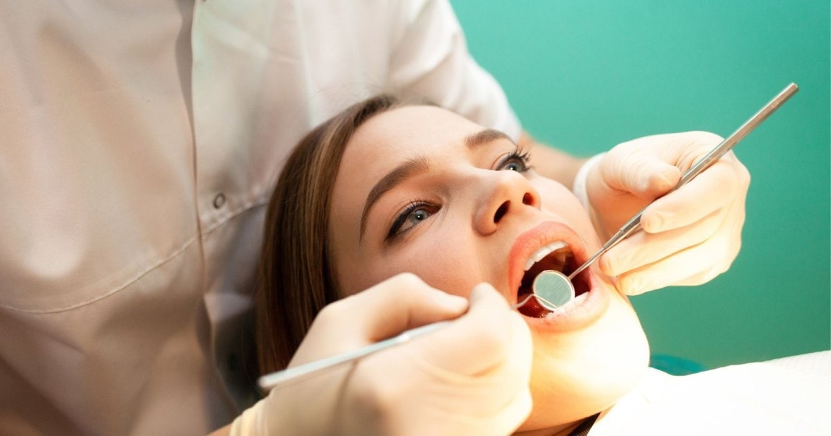 Dentist examining a patient's mouth during a dental check-up in Yeronga